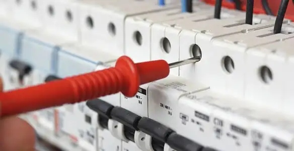 Electrical contractor testing circuit breakers during electrical repair in Chalmette, LA