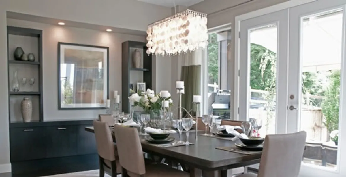 Elegant dining room chandelier installation above table in New Orleans, LA