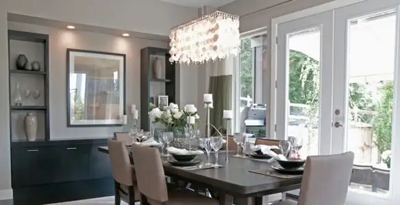 Elegant dining room chandelier installation above table in New Orleans, LA
