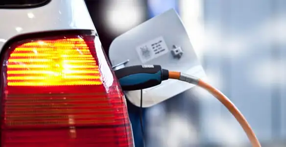 Electric car plugged into EV charger after professional installation in New Orleans, LA