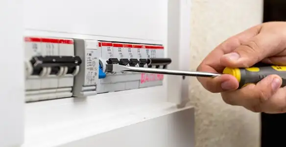 electrical panel upgrade service showing technician adjusting circuit breakers during system upgrade in New Orleans, LA