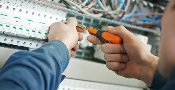 electrical service showing licensed electrician performing electrical panel maintenance and adjustments in New Orleans, LA
