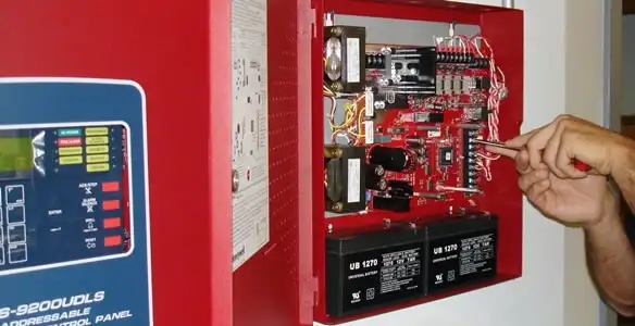 fire alarm installation service showing technician configuring fire alarm control panel in New Orleans, LA