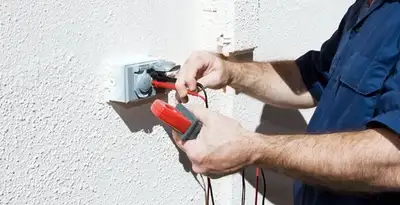 Electrician performing home electrical outlet and wiring inspection in New Orleans, LA