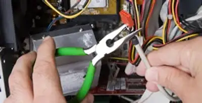 Licensed electrical contractor performing electrical repair with tools in Chalmette, LA