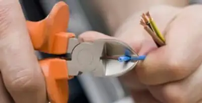 professional electrical services showing precise wire cutting by licensed electricians in New Orleans, LA