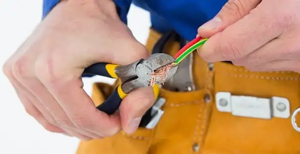 licensed electrician securing electrical wiring with professional tools during service work in New Orleans, LA