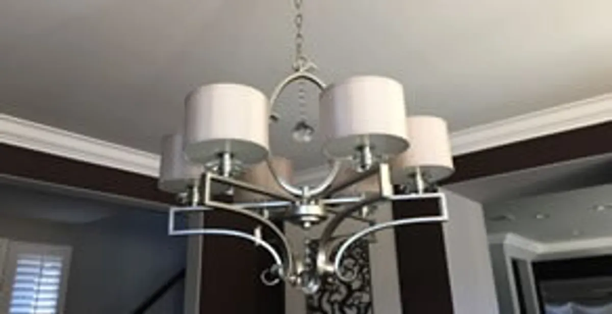 Modern chandelier installation with multiple light fixtures in New Orleans, LA