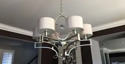 Modern chandelier installation with multiple light fixtures in New Orleans, LA