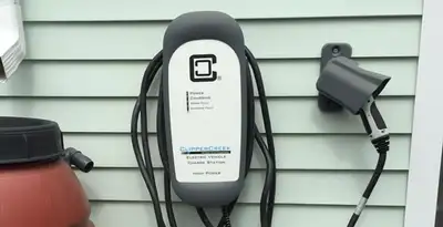 Outdoor electric vehicle charger installation on residential wall in New Orleans, LA