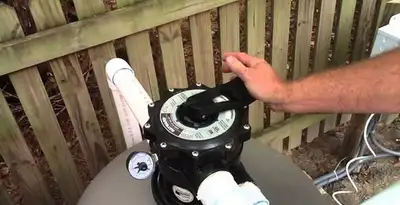 pool pumps service showing professional adjustment of pool pump control system in New Orleans, LA