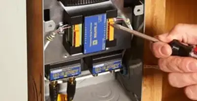 Whole home surge protection device being installed by a licensed electrician to protect electrical systems in New Orleans, LA